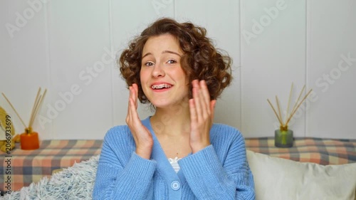 cute young girl with braces feels strong joy and pleasure after installation following orthodontic treatment on her teeth, a happy moment of dental care success