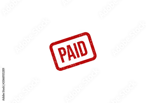 Red grunge rubber stamp with the word paid printed on paper surface