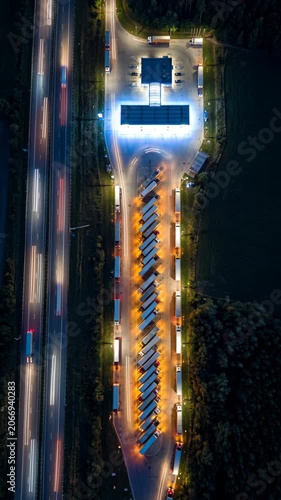 Aerial night view of highway traffic with motion blur and busy truck