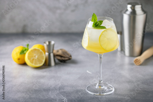Homemade Limoncello spritz drink of liqueur, sparkling wine and lemon in Wine  glass