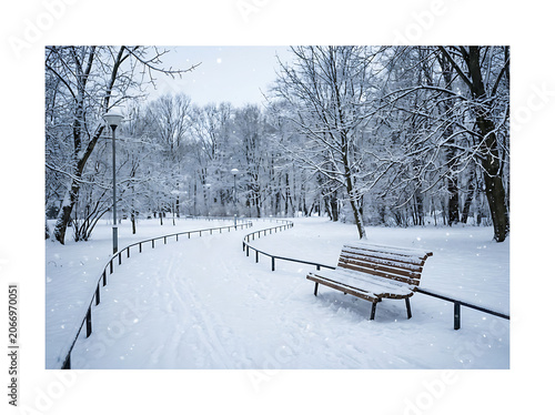 Vintage wooden bench in snowy park.