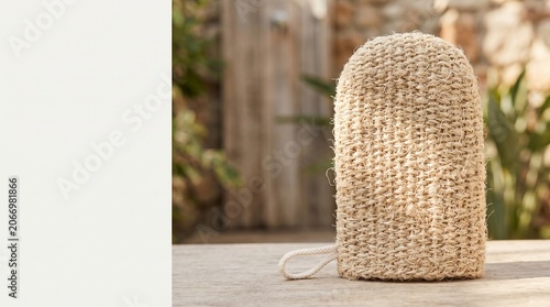 Natural woven kitchen glove on wooden table in rustic setting  