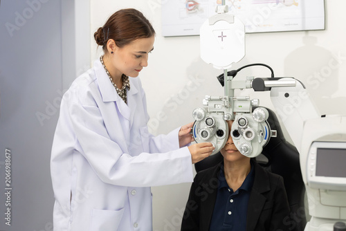 Foto Patient receives eye exam with vision testing equipment at an optometry clinic