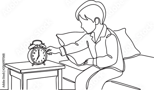 Schilderij op canvas Young boy waking up and turning off alarm clock in the morning