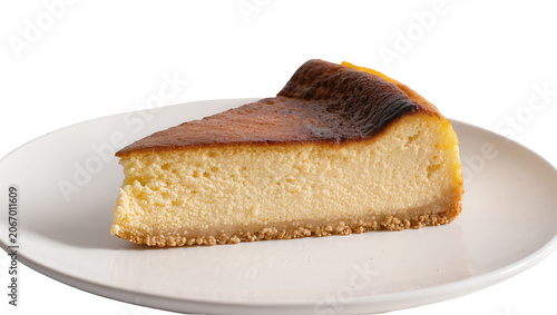 Fotografía Isolated a delicious slice of rich and creamy Basque burnt cheesecake dessert on