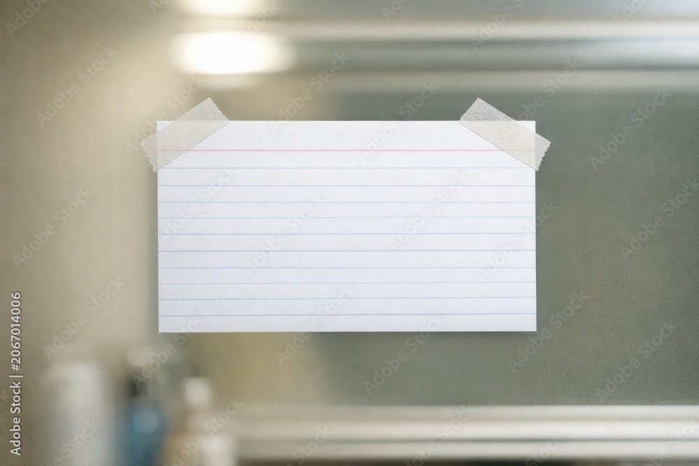 Obraz premium A piece of paper taped to a mirror with handwritten notes or reminders