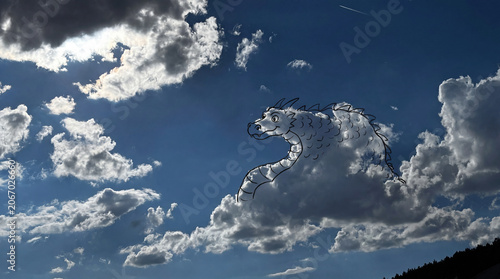 Creative conceptual overlay of a dragon outline drawn onto a natural shape in the clouds.
