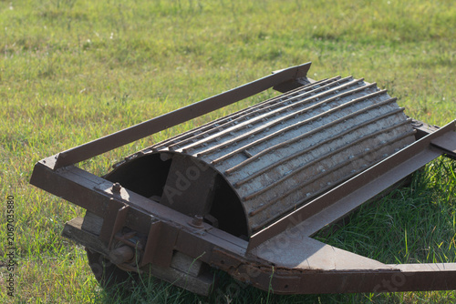 Old cultivation rollers on the field. Soil cultivation in an agricultural field in spring.