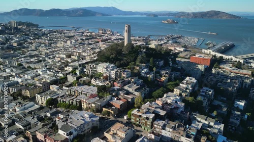 Cinematic drone footage orbiting around Coit Tower on Telegraph Hill in San Francisco. Smooth aerial movement showcasing the iconic Art Deco landmark.