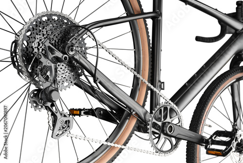 Detailed close-up of a modern gravel bicycle drivetrain. Multi-speed cassette, rear derailleur, chain and crankset isolated on white background.