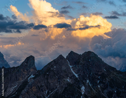 Cuadro en lienzo Dramatic storm clouds engulf rugged Dolomite mountain peaks at sunset in northern Italy