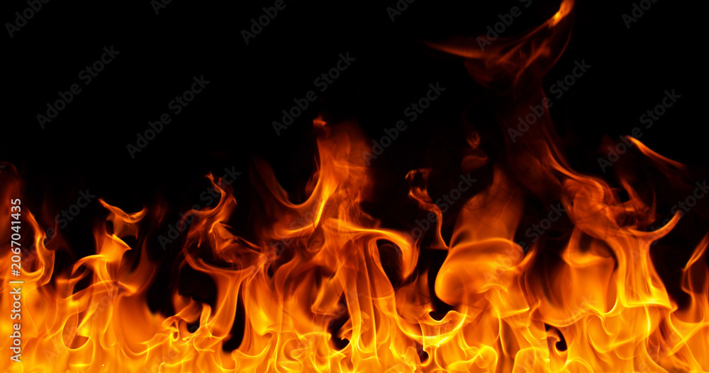 Fototapeta premium Burning orange flames with glowing embers isolated on black background. Realistic fire effect suitable for visual effects, compositing, motion graphics and video editing.