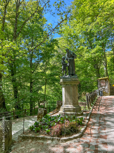 A statue of St. Francis among the trees, near the Franciscan monastery in La Verna, Italy, at the site where St. Francis received the stigmata.