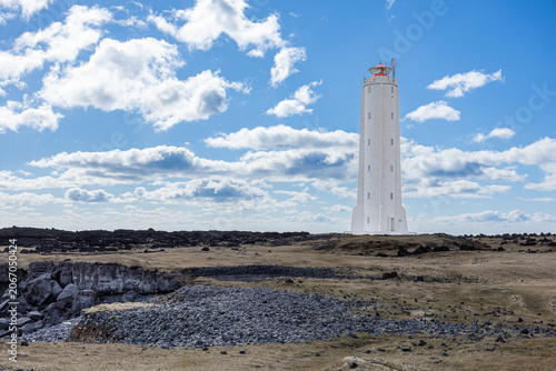 White Lighthouse Rising Above Lava Fields on the Rugged Coast of Western Iceland