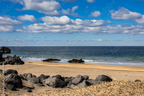Basalt Stones and Sandy Shoreline Along Scenic Icelandic Atlantic Coast