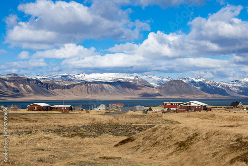 Icelandic Coastal Village with Snow Covered Mountains and Fjord Landscape Under Blue Sky