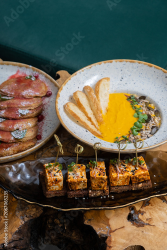 Tasty dishes are served on a wooden table in a restaurant setting during brunch hours