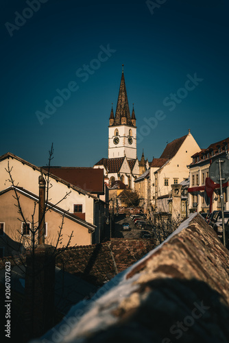 Lutheran Cathedral spire rising over the old town rooftops of Sibiu, Romania