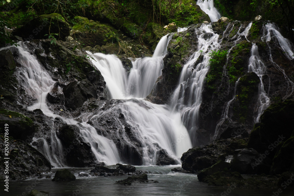 Fototapeta premium Beautiful Multi-Tiered Waterfall Cascading into a Pool in Panama Rainforest