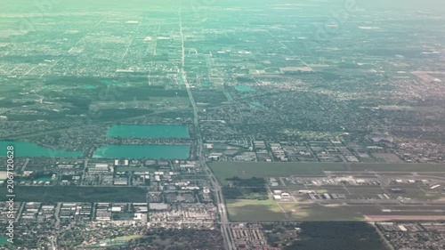 Beautiful view from airplane window of suburban landscape and forests below. Dominican Republic.