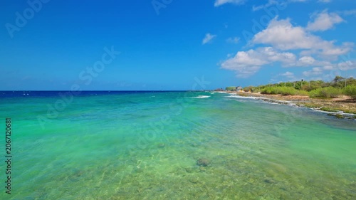Beautiful view of clear Caribbean Sea coastline with turquoise water on background of blue sky. Curacao.