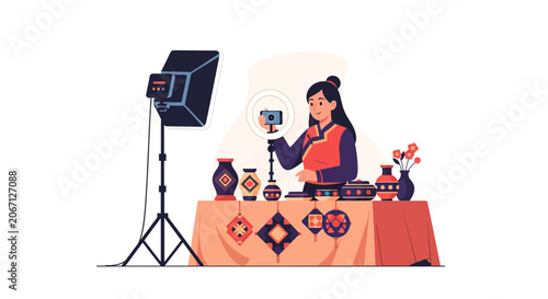 Young woman in traditional clothing records a product video with a ring light and camera, showcasing pottery and crafts for online sales.
