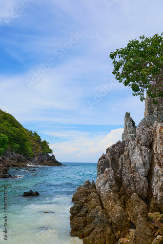 Rocky Shoreline with Clear Turquoise Sea and Gentle Waves, Tropical Coastal Landscape