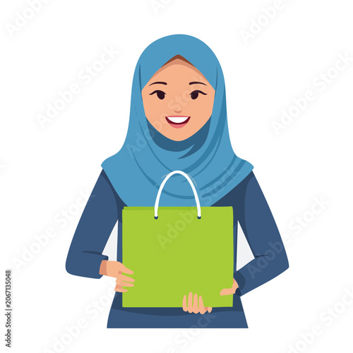 Smiling woman in hijab holding green shopping bag