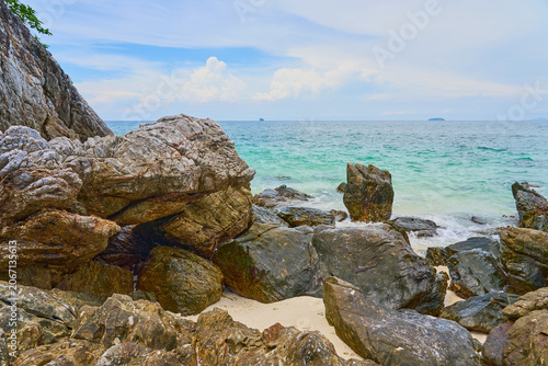 Rocky Shoreline with Clear Turquoise Sea and Gentle Waves, Tropical Coastal Landscape