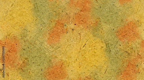 Seamless textured handmade mulberry paper background with green, yellow and orange abstract mottled patterns