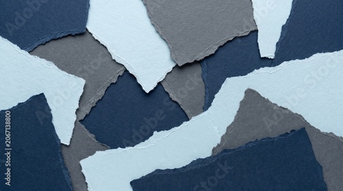 Abstract background of torn paper pieces in shades of blue and gray