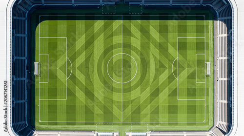 Aerial top down view of a professional soccer field featuring a unique geometric pattern of circles and diamonds on the green grass within a large stadium