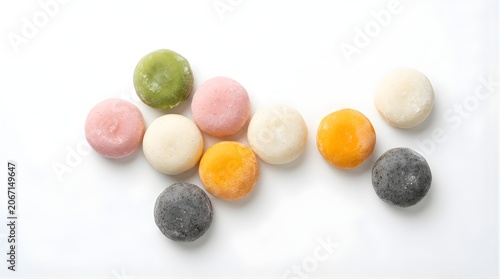 Top view of colorful mochi rice cakes in pink green orange black and white assortment for traditional japanese sweets