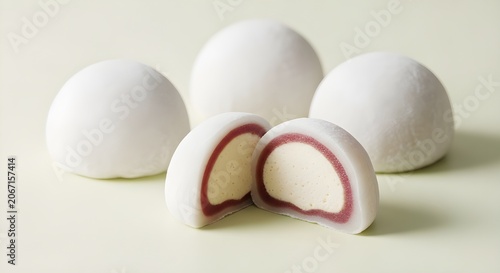 Traditional Japanese mochi dessert with sweet filling cut in half on light background