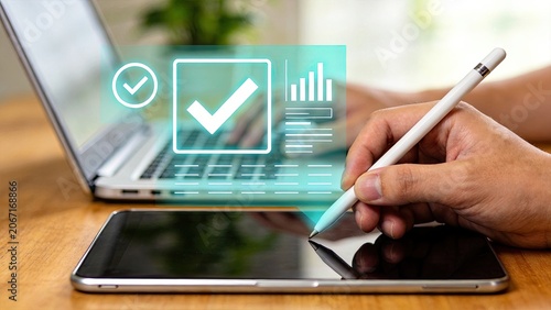 Hand using stylus on tablet with checklist and analytics graphic overlay, digital planning tool, productivity app interface, task management system, data visualization