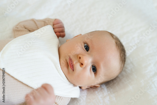 Valokuva Portrait of a two to three month old baby with visible drool on lips
