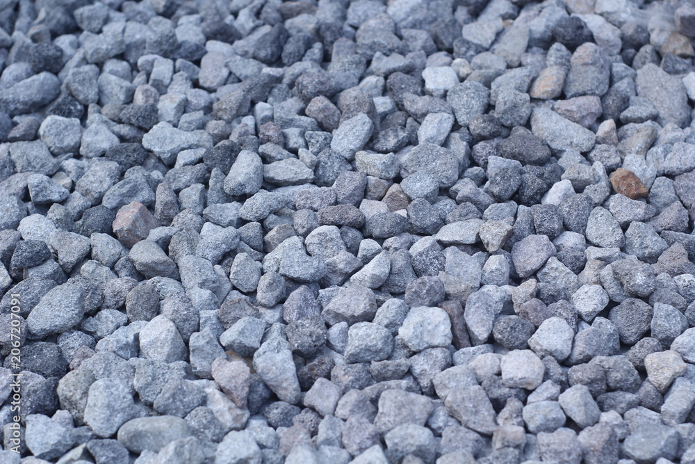 Ταπετσαρία A high-angle, close-up shot of a pile of grey crushed stones and gravel, showing a rough texture suitable for construction, roadwork, or landscaping backgrounds