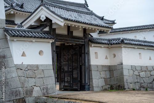 Historic entrance gate of a Japanese castle with stone walls