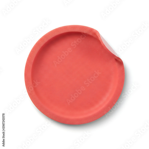 A round terracotta-colored plate with a slightly uneven rim displayed against a plain background