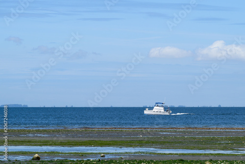 Fotografie Boating in Puget Sound on a sunny spring day, white yacht off the coast at low t
