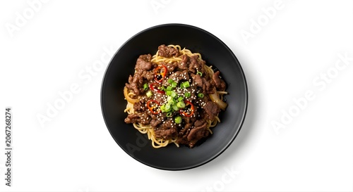 Isolated stir fried beef noodles in black bowl with chili and sesame seeds for asian restaurant menu culinary photography