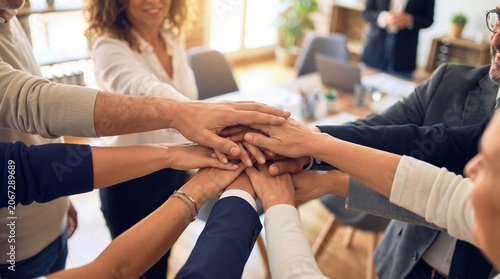 Multiethnic business team joining hands together in a circle as a symbol of unity and successful collaboration