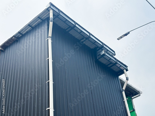 Quadro su tela Modern Industrial Building with Black Corrugated Metal Siding and PVC Rain Gutte