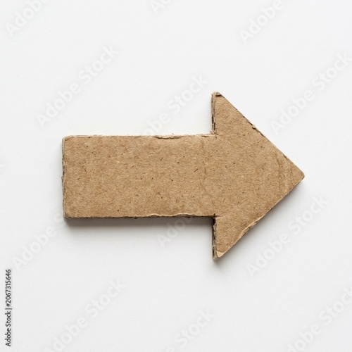 Thick cardboard arrow cutout isolated on white background