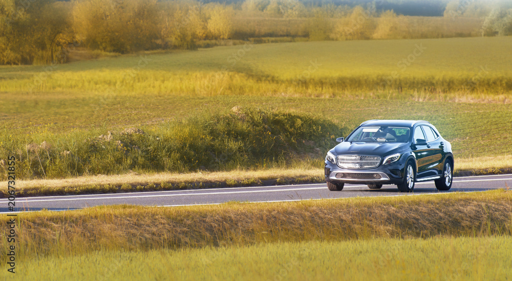 Fototapeta premium Automobile traveling on a peaceful rural road