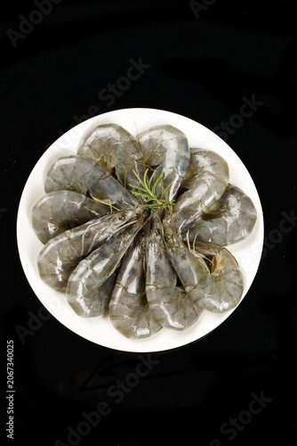 Fresh Raw Prawns with Rosemary on White Plate