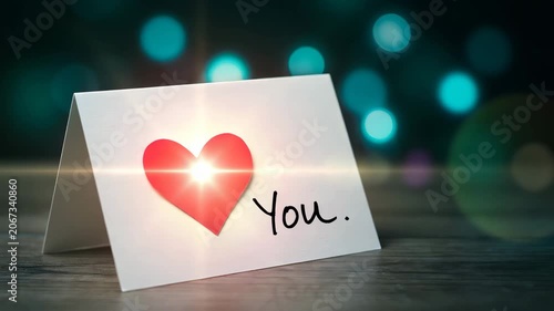Romantic love card with red heart and you text on wooden table with bokeh lights background for valentines day or anniversary wishes and greetings