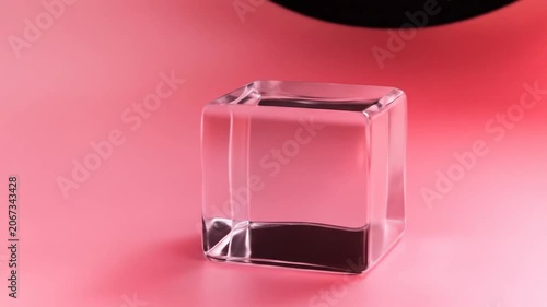Transparent cube on pink surface minimalist abstract composition