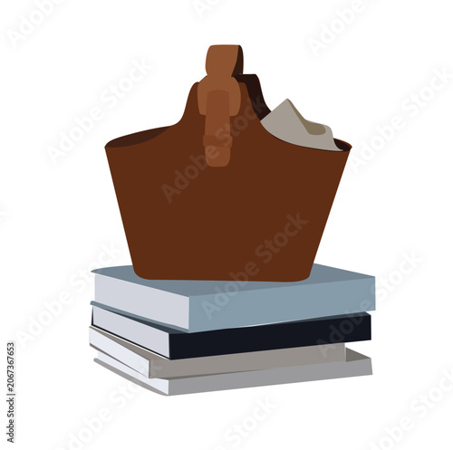 the bag is placed on top of a pile of books
