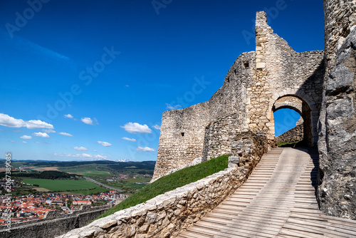 Stone entrance gate and wooden walkway leading into Spis Castle above Spišské Podhradie in Slovakia